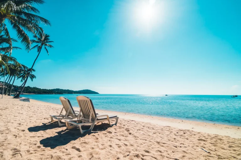 Beautiful tropical beach sea with chair blue sky